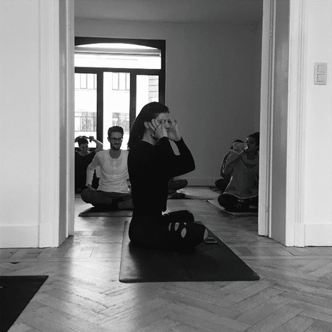 A woman from Ketchum Brussels on a yoga mat