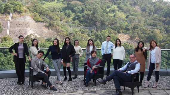 A group of female and male Ketchum Hong Kong colleagues sitting and standing outside