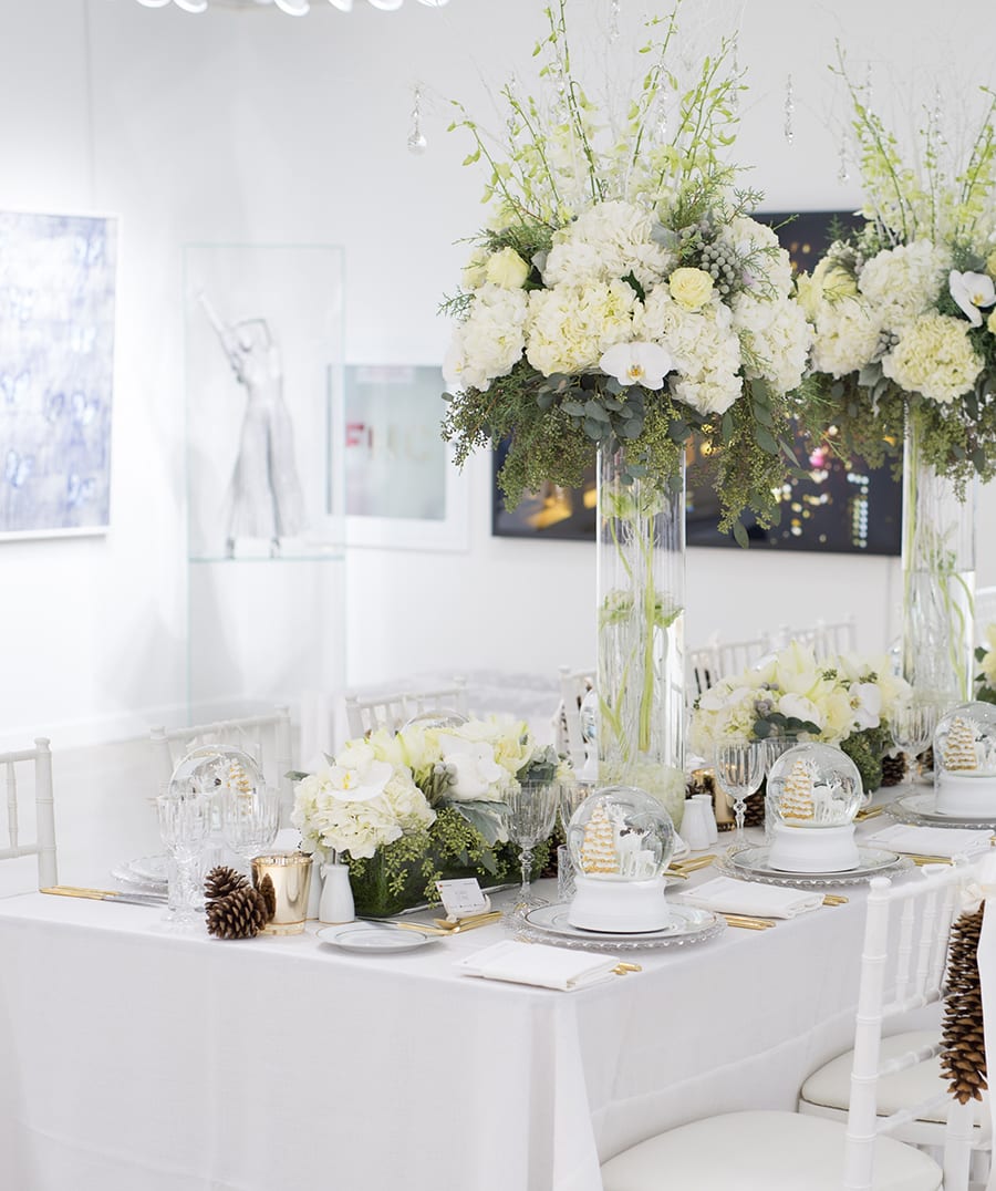 Mastercard logo over white flowers and white themed dining table