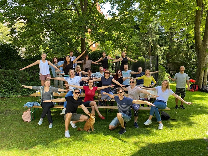 A group of female and male Ketchum Vienna colleagues on picnic table outside