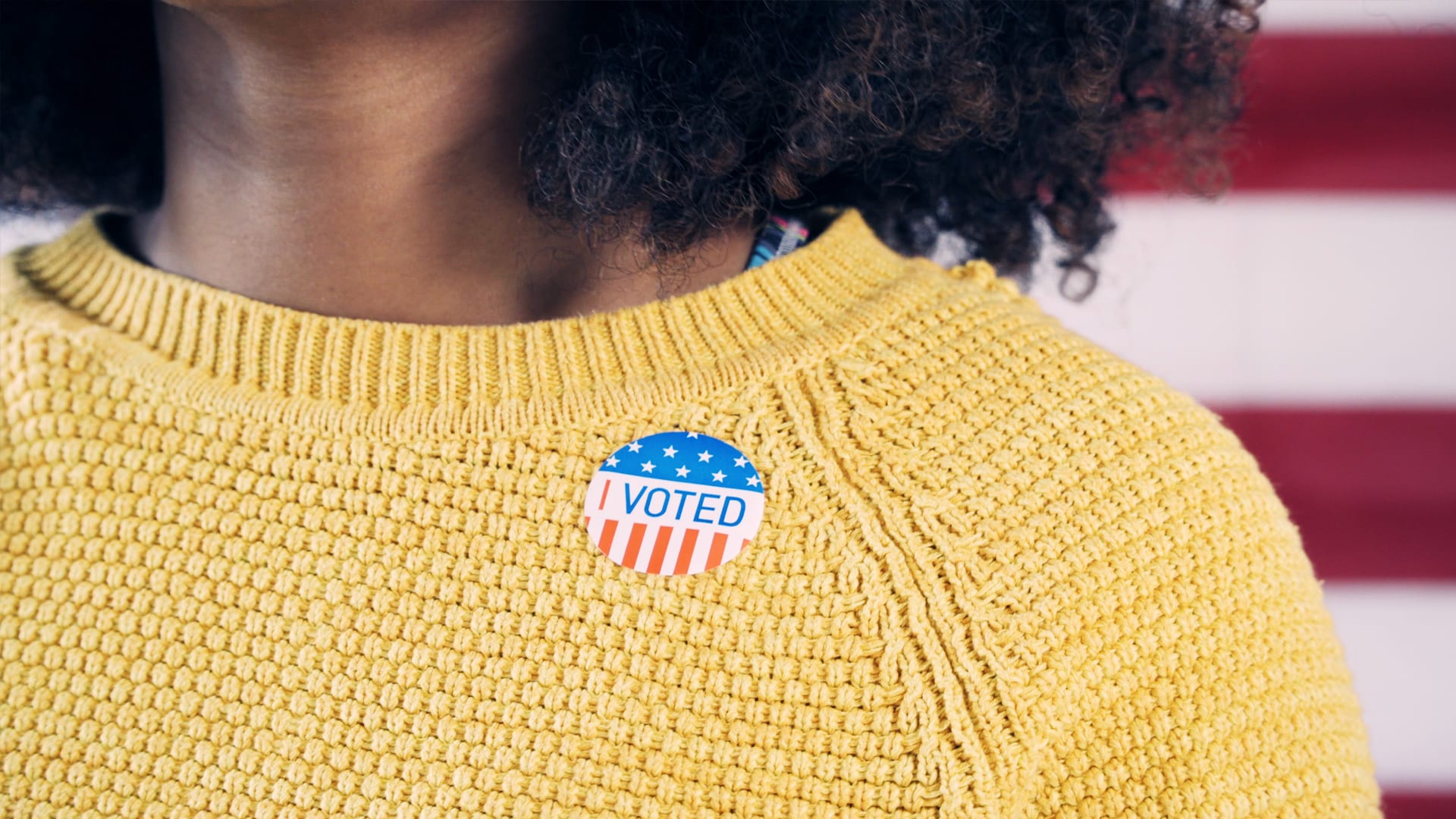 Image of sweater with I Voted sticker.