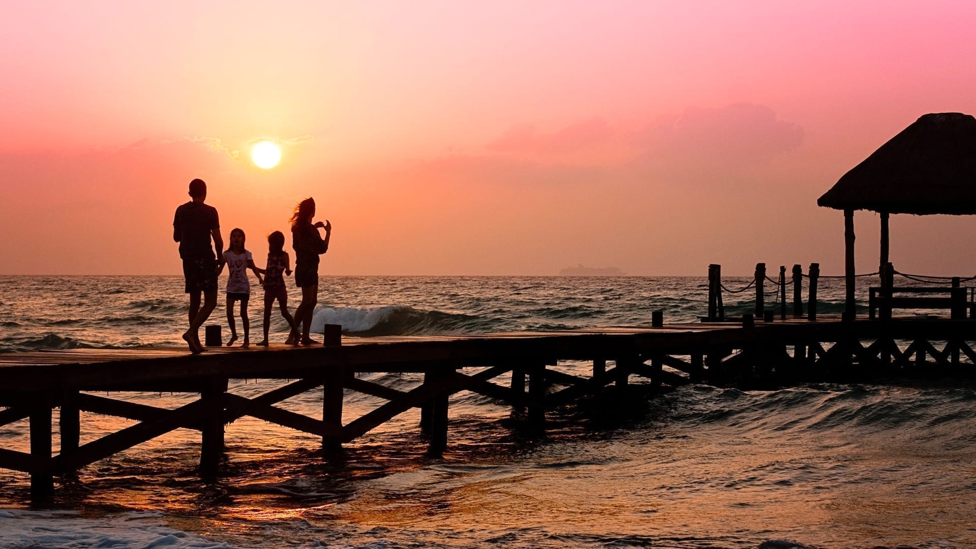 2021 Summer Travel Trends — with a Glimpse at Fall and Winter - photo of a family on a seaside dock at sunset