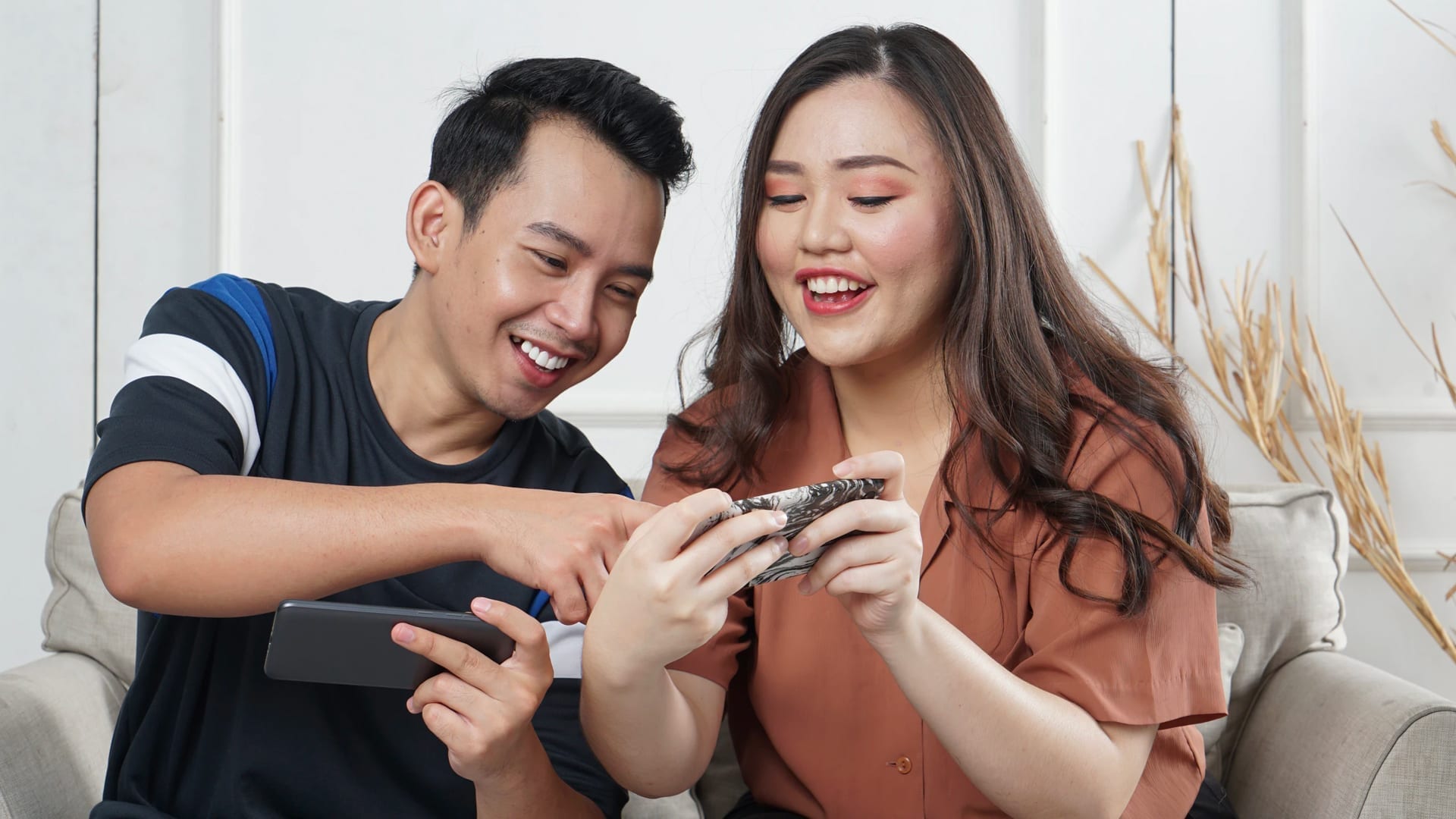 Esports Rising Shows That Gaming Keeps Growing - photo of man and woman gaming on their phones