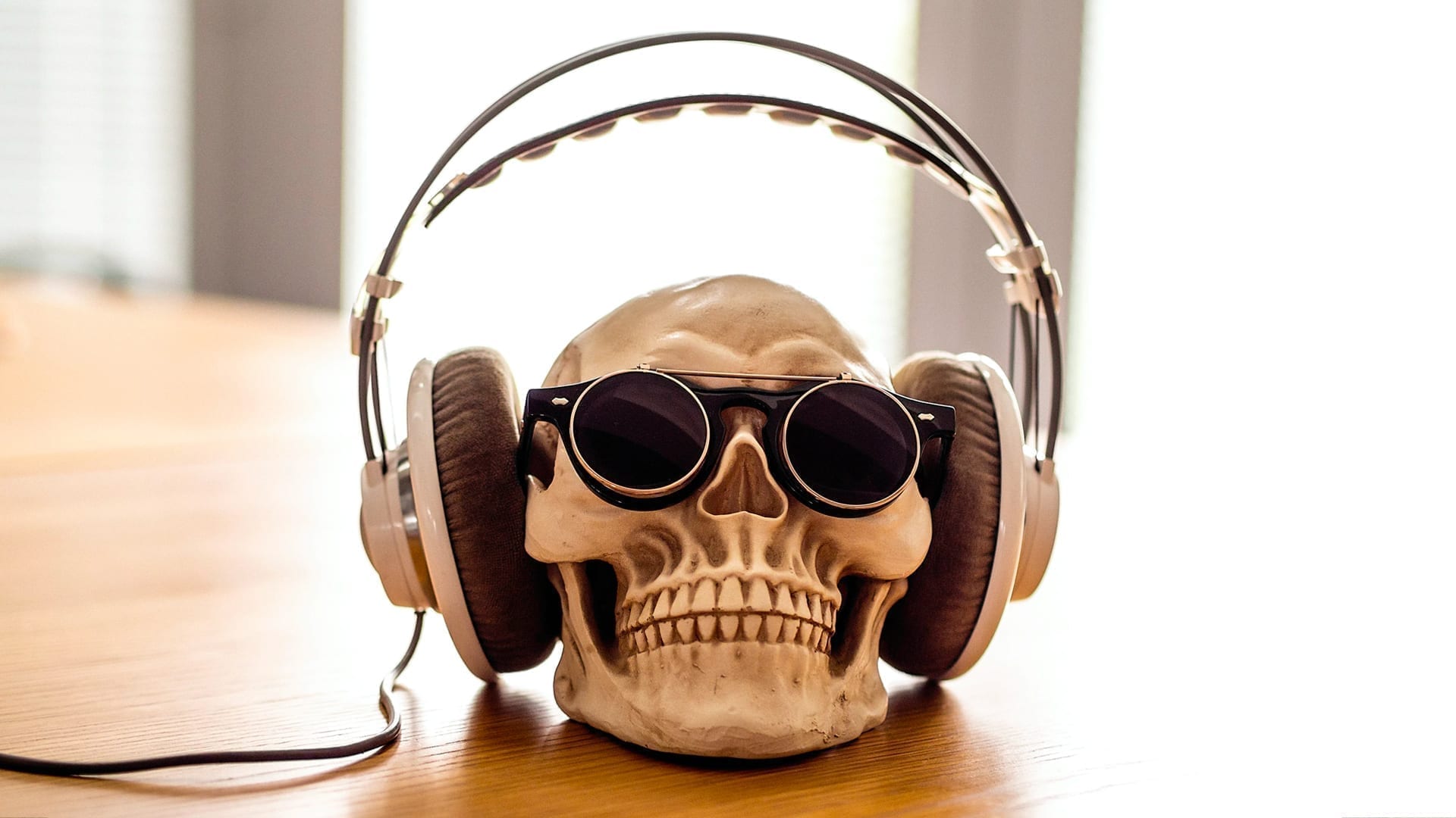 How Listening to Murder Podcasts Helps with Storytelling - photo of a skull wearing headphones