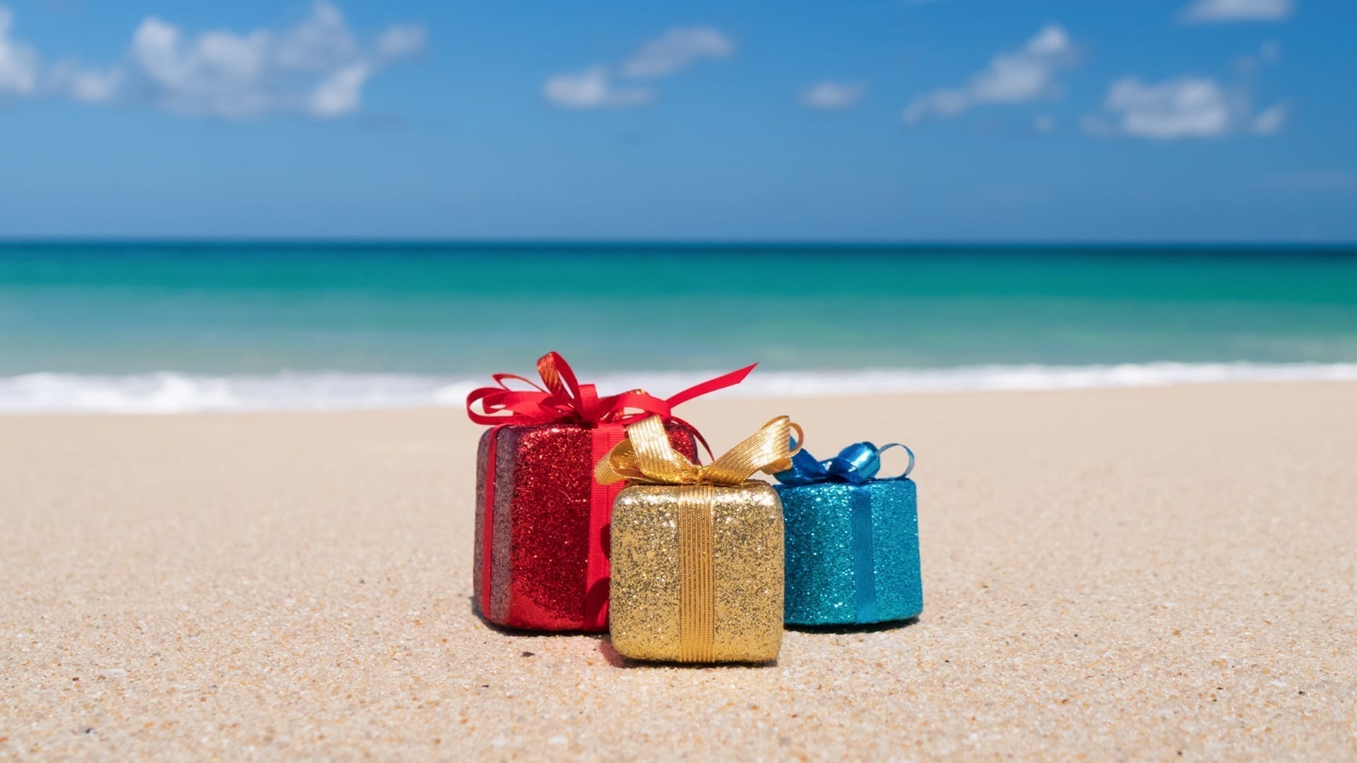 ‘Tis the Season to Set Your Holiday Marketing Strategy - photo of wrapped gifts on a beach