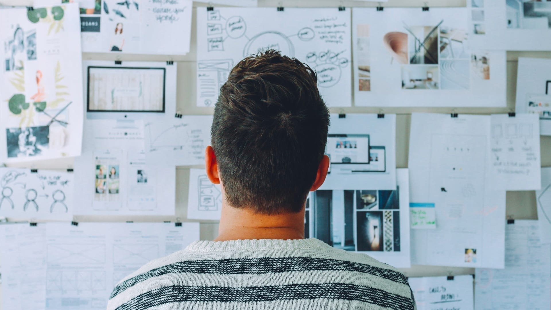 Getting Started with the Strategic Planning Process - man looking at pages of notes pinned to a wall