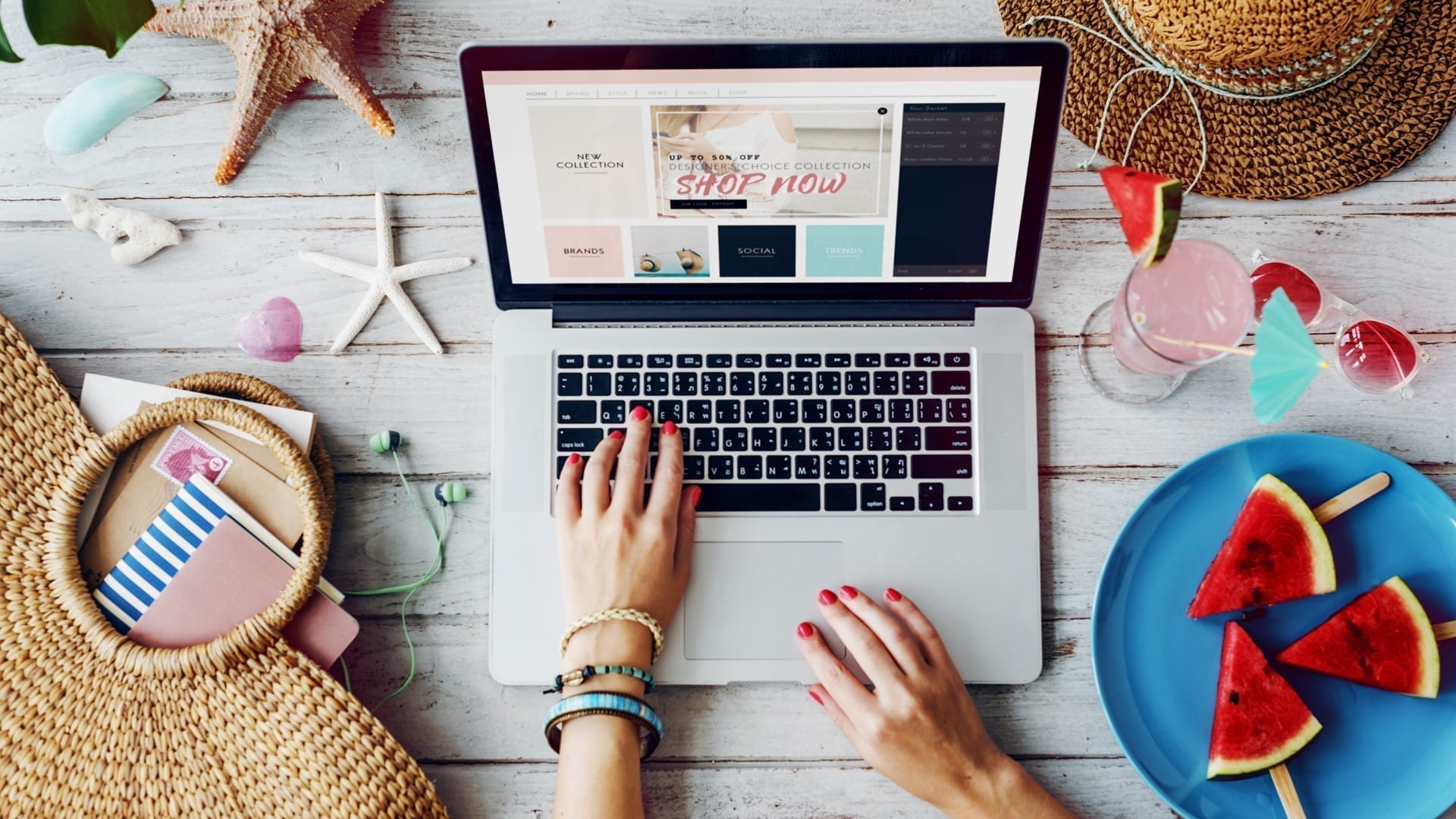 Summer Sales Events- The Big Picture for Retailers - photo of woman's hands on laptop viewing an online sale surrounded by summery objects