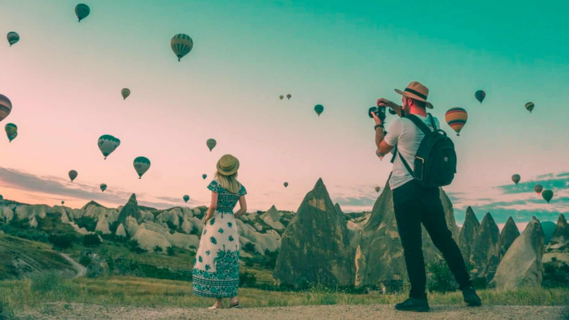 Person taking photo of person watching hot air balloons in the sky displaying example of influencer marketing trends.