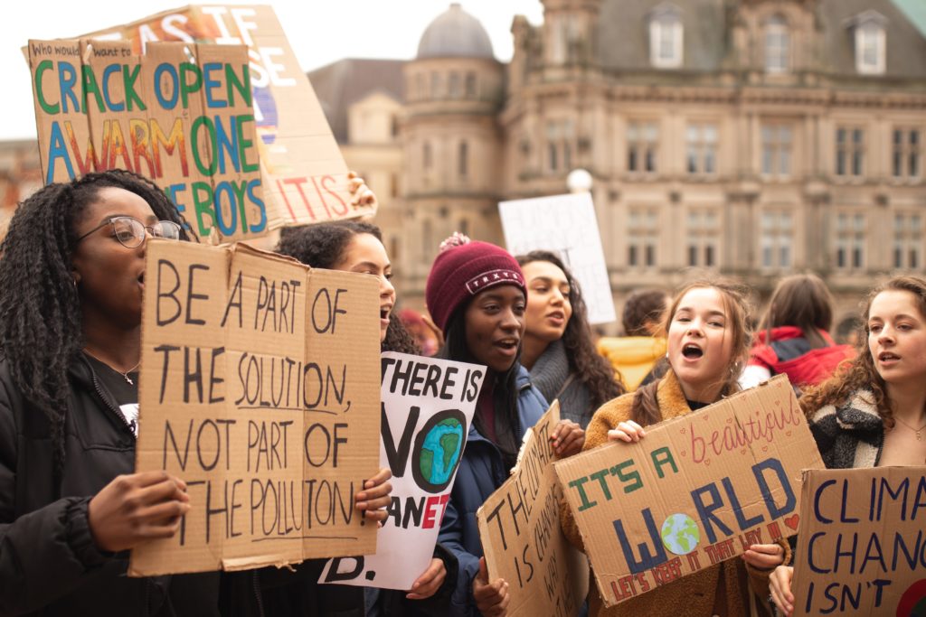 Young people holding signs about climate and nature