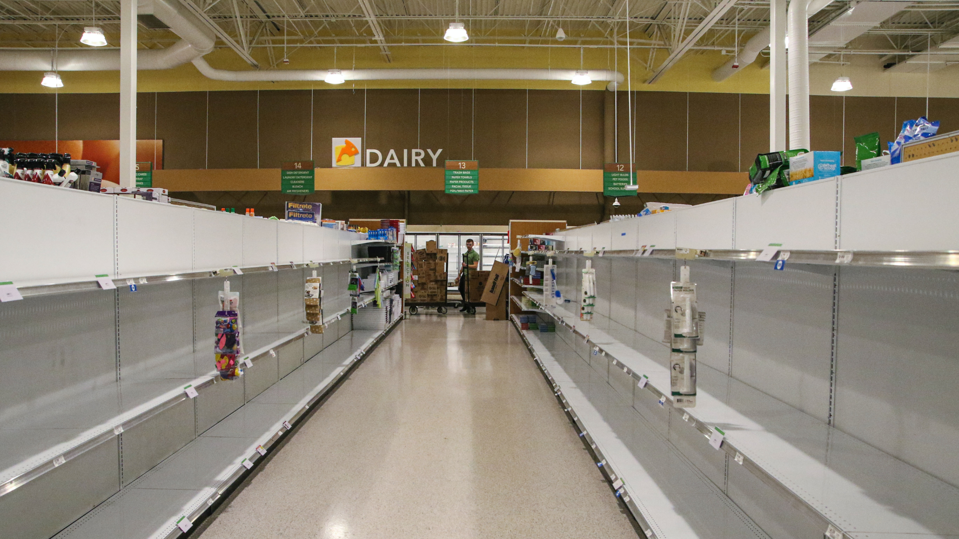 Empty shelves in a grocery store near Dairy section